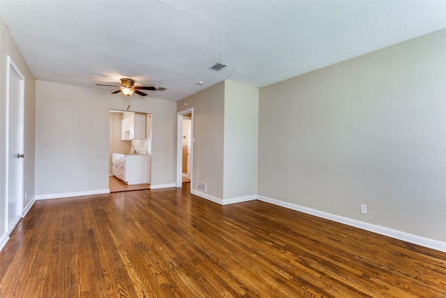 unfurnished room with visible vents, baseboards, a ceiling fan, and wood finished floors