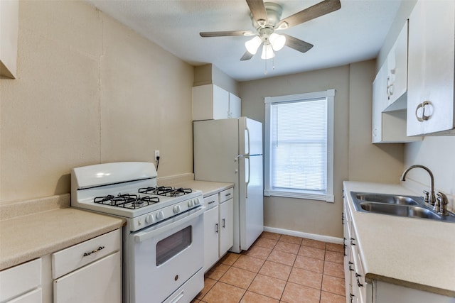 kitchen featuring white appliances, white cabinets, light tile patterned floors, and a sink