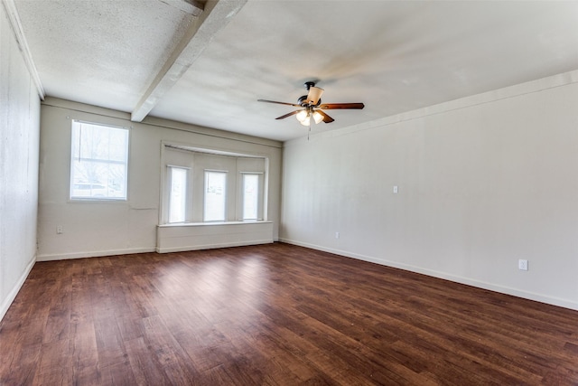 unfurnished room with dark wood-style floors, ceiling fan, a textured ceiling, and baseboards