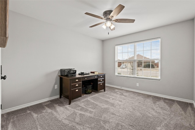 carpeted home office with baseboards and a ceiling fan