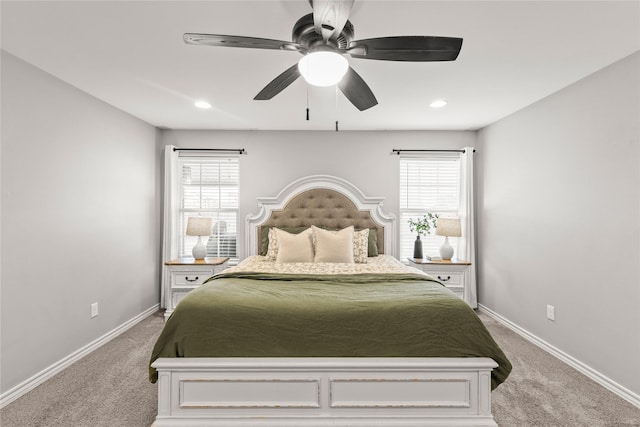 carpeted bedroom with multiple windows, baseboards, and ceiling fan