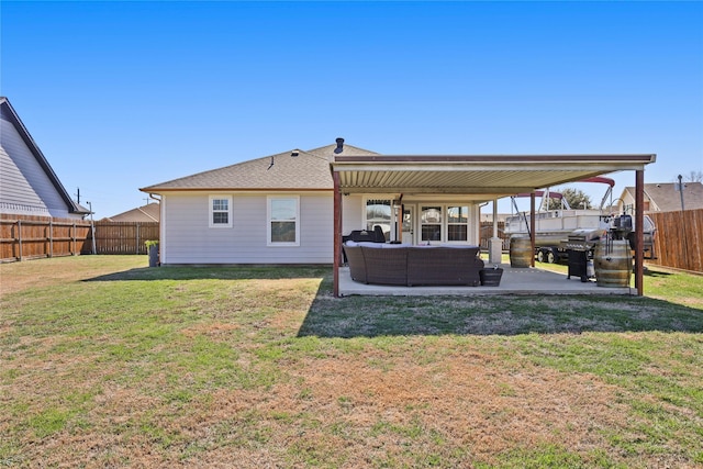 back of property with a fenced backyard, a yard, outdoor lounge area, a shingled roof, and a patio area