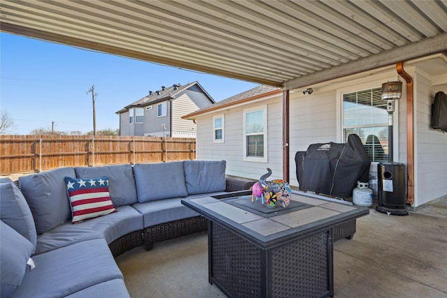 view of patio / terrace featuring area for grilling, an outdoor living space, and fence