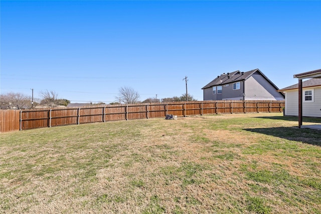 view of yard with a fenced backyard