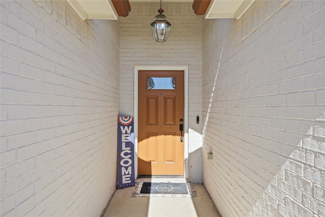 view of exterior entry with brick siding