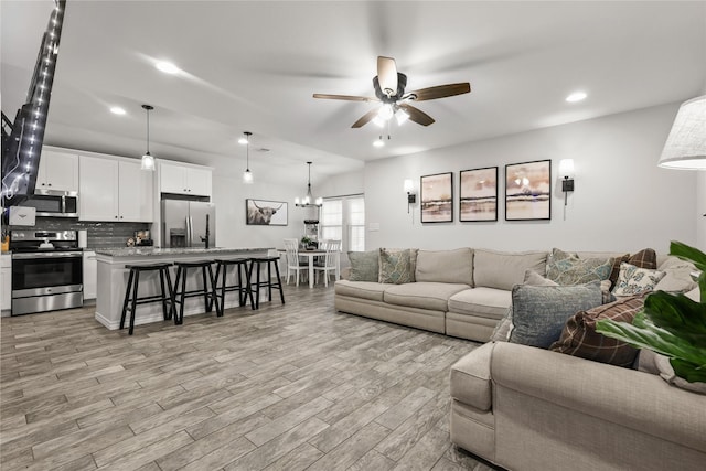 living area featuring recessed lighting, a ceiling fan, and light wood finished floors