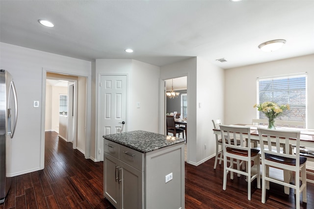 kitchen featuring stone countertops, baseboards, dark wood-type flooring, and recessed lighting