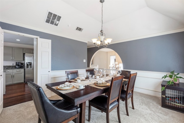 dining space with a notable chandelier, visible vents, and a wainscoted wall