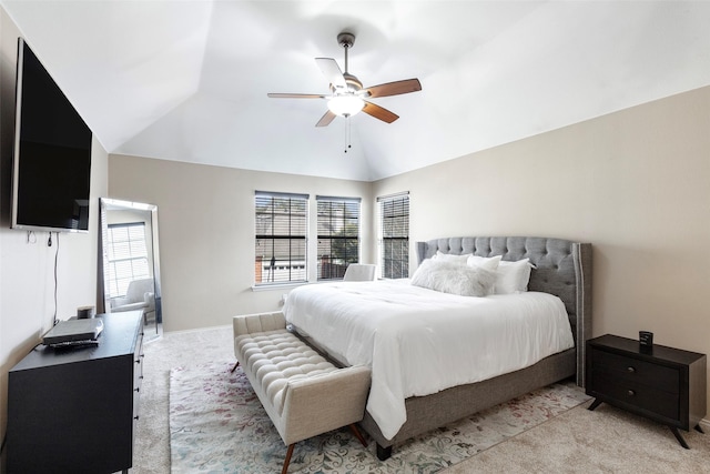 bedroom with light carpet, ceiling fan, and vaulted ceiling