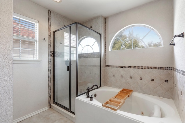 bathroom with a shower stall, tile patterned floors, and a whirlpool tub