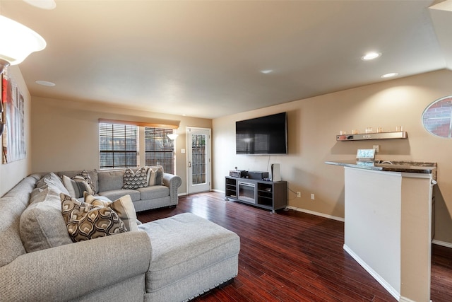 living room with dark wood finished floors, recessed lighting, and baseboards