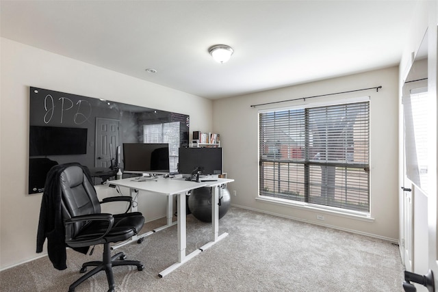 carpeted office space featuring a wealth of natural light and baseboards