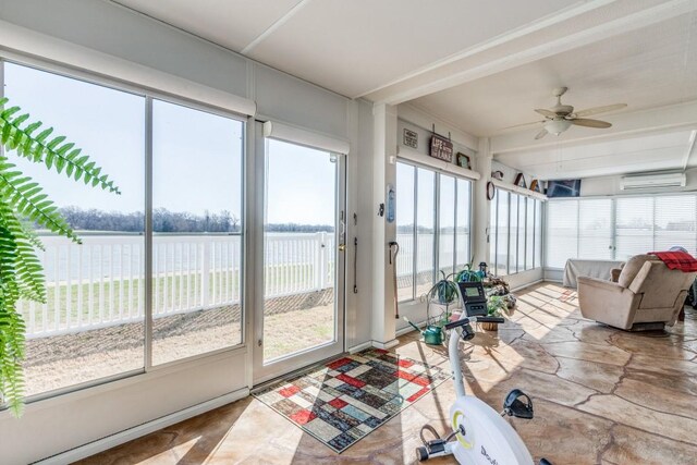 sunroom with plenty of natural light, an AC wall unit, and ceiling fan