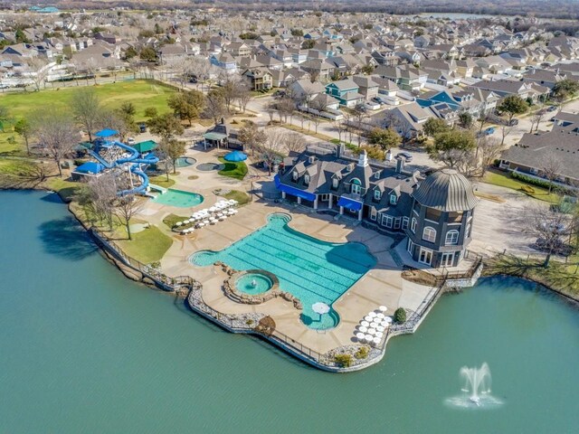 drone / aerial view featuring a residential view and a water view