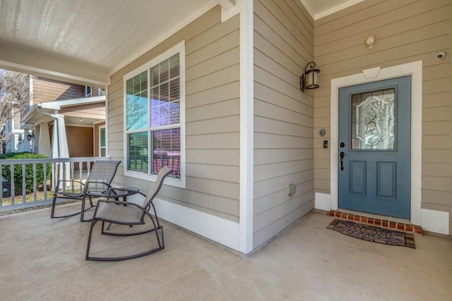 entrance to property featuring covered porch