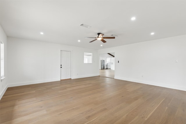 unfurnished living room with visible vents, a ceiling fan, recessed lighting, light wood finished floors, and baseboards