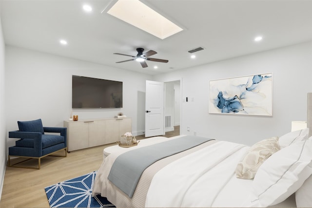 bedroom featuring recessed lighting, visible vents, light wood-style floors, and a skylight