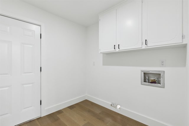 clothes washing area featuring hookup for a washing machine, baseboards, cabinet space, electric dryer hookup, and dark wood-type flooring