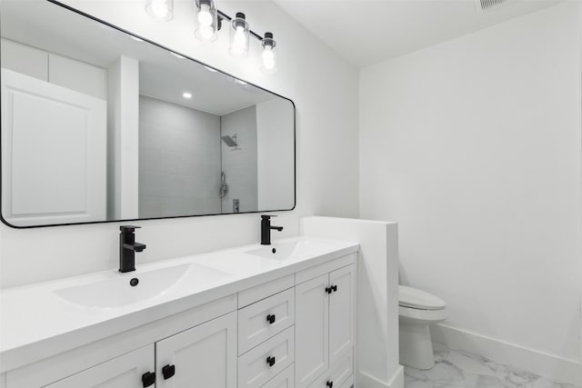 full bath with a sink, baseboards, toilet, and marble finish floor