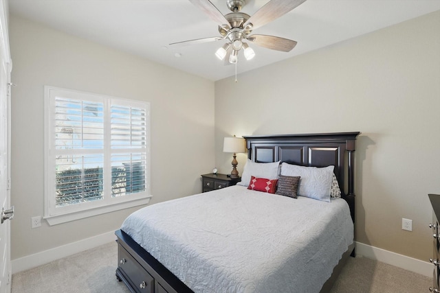 bedroom featuring ceiling fan, baseboards, and light carpet