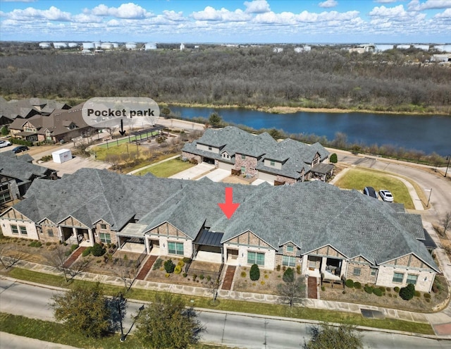 drone / aerial view featuring a residential view and a water view