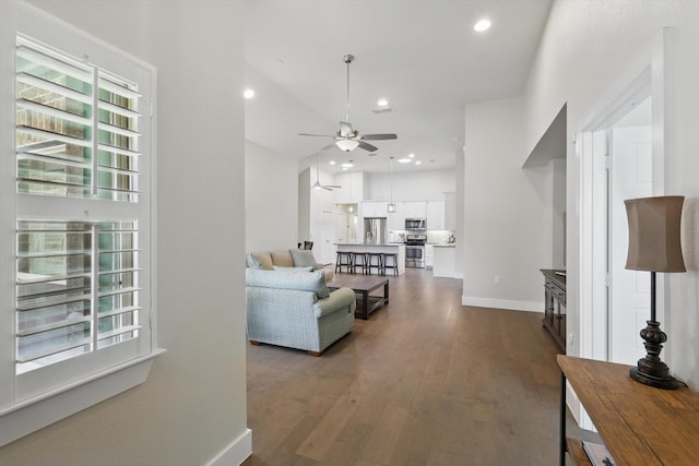 living room featuring dark wood-style floors, recessed lighting, a ceiling fan, and baseboards