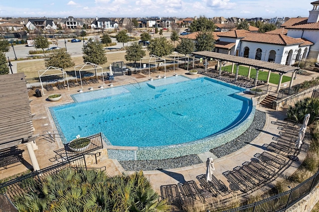 view of pool featuring fence and a residential view