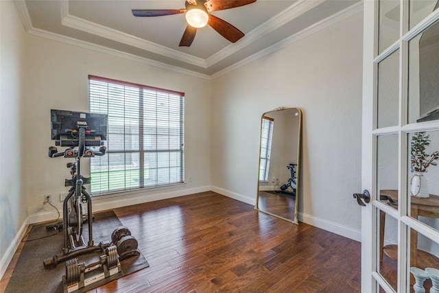 workout area with a ceiling fan, wood finished floors, baseboards, ornamental molding, and french doors