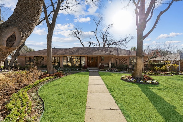 ranch-style home with a front yard