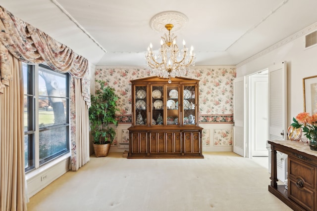 dining room featuring carpet, a chandelier, and wallpapered walls