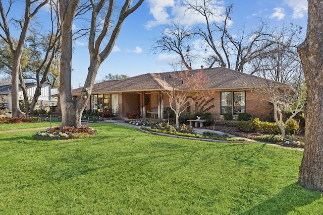 single story home with brick siding and a front lawn