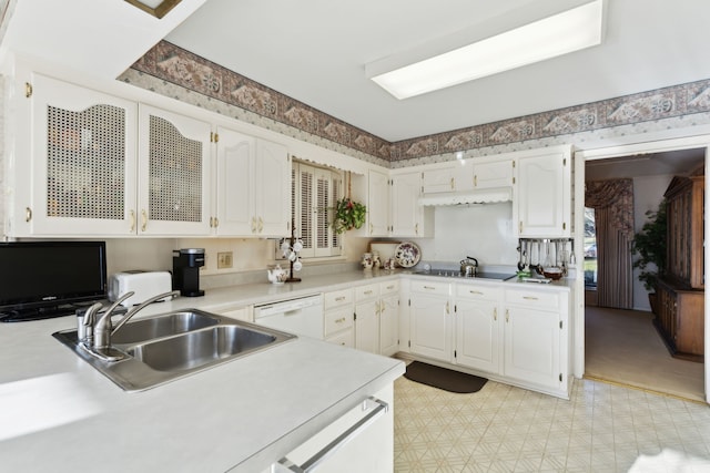 kitchen with a sink, white cabinets, white dishwasher, and light countertops