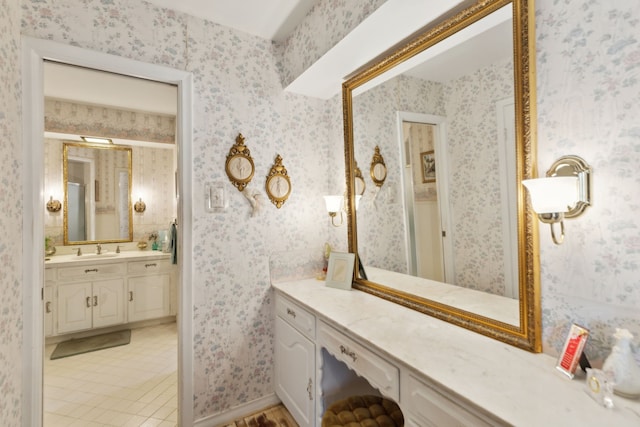 full bathroom with wallpapered walls, vanity, and tile patterned flooring