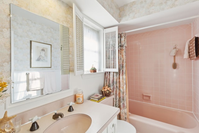 bathroom featuring toilet, shower / bath combo, and vanity