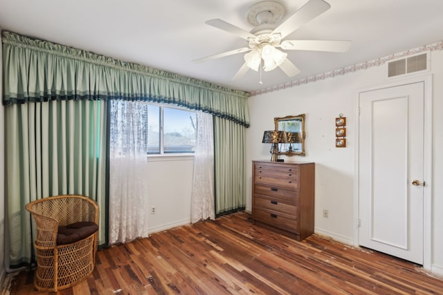 bedroom featuring visible vents, ceiling fan, baseboards, and wood finished floors