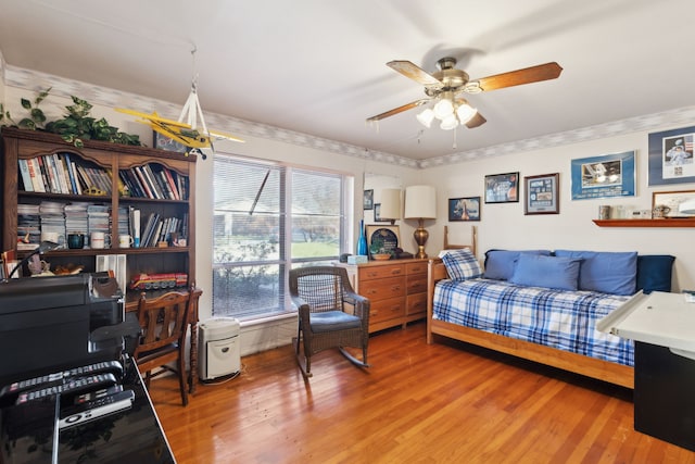 bedroom featuring light wood finished floors and a ceiling fan