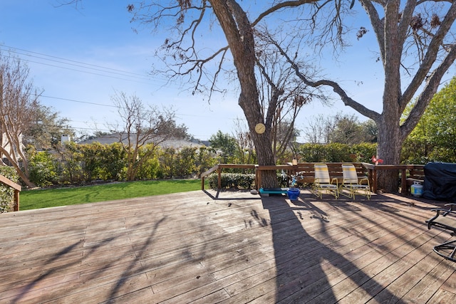 wooden terrace with a grill