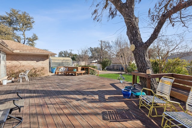 wooden terrace featuring fence