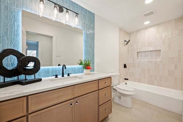 bathroom with vanity, visible vents, tile patterned flooring, bathing tub / shower combination, and toilet