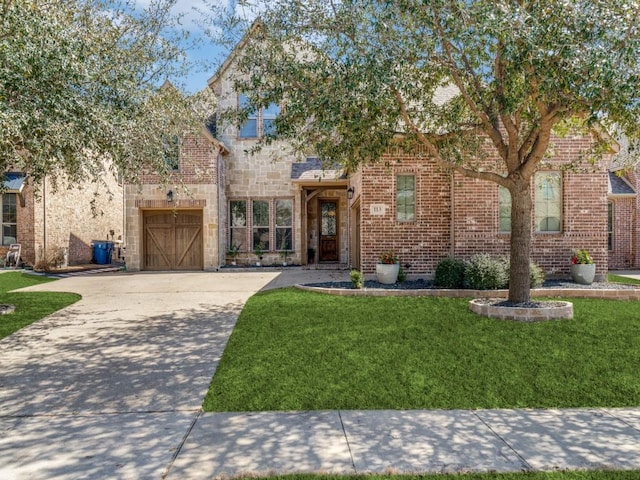 view of front of property with stone siding, concrete driveway, a front yard, a garage, and brick siding