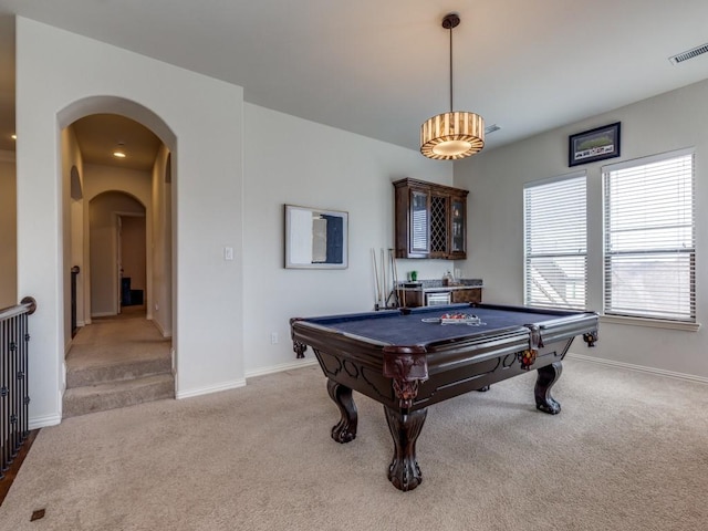 playroom featuring baseboards, light colored carpet, visible vents, and arched walkways