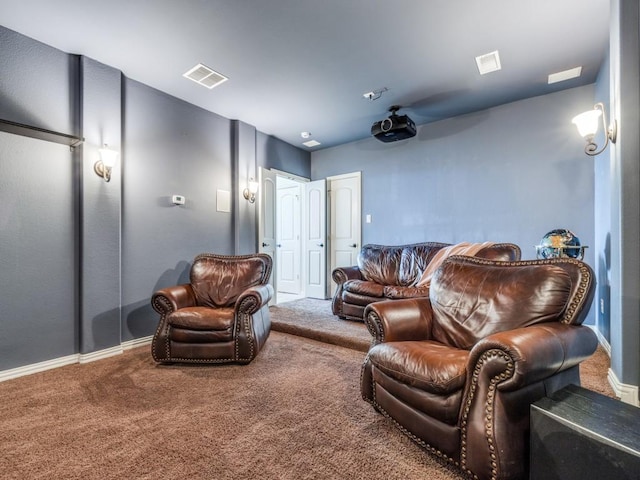 carpeted home theater room featuring baseboards and visible vents