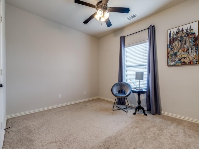 interior space featuring visible vents, carpet floors, baseboards, and a ceiling fan