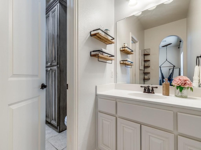 bathroom with vanity, toilet, and tile patterned flooring