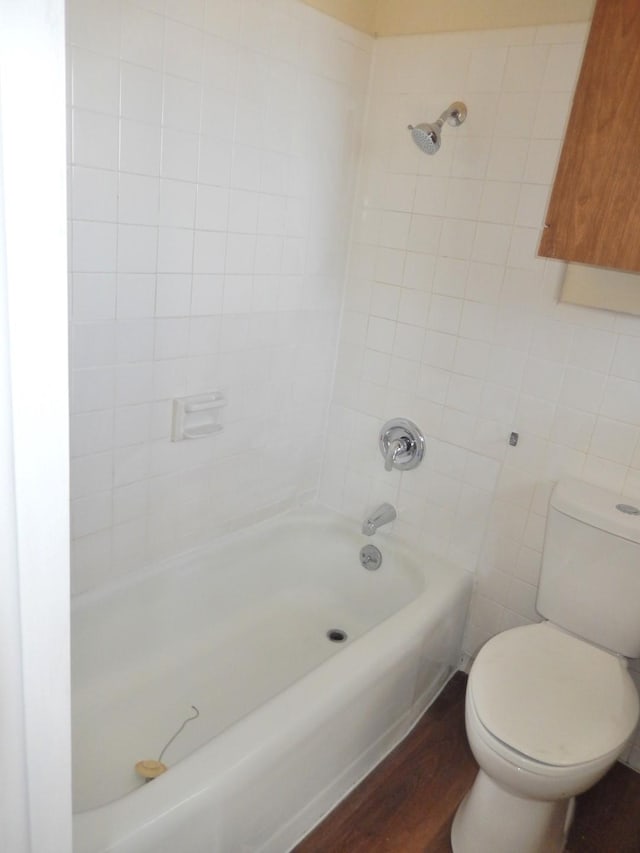 bathroom featuring shower / bathing tub combination, toilet, and wood finished floors