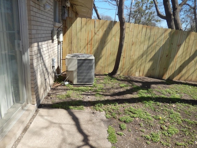 exterior details featuring central air condition unit and fence