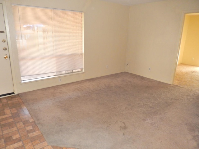 unfurnished room featuring carpet flooring