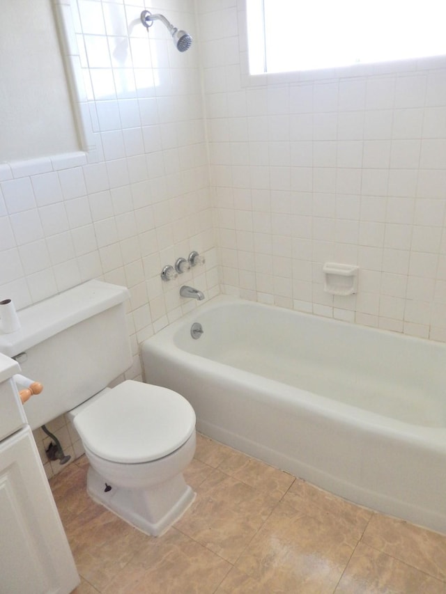 bathroom featuring vanity, toilet, and bathing tub / shower combination