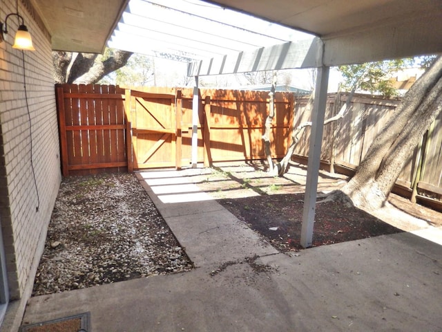 view of patio featuring a gate and fence