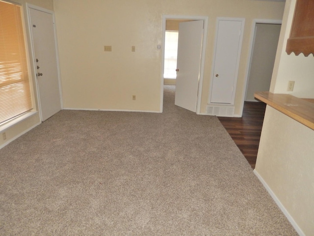 unfurnished living room featuring baseboards